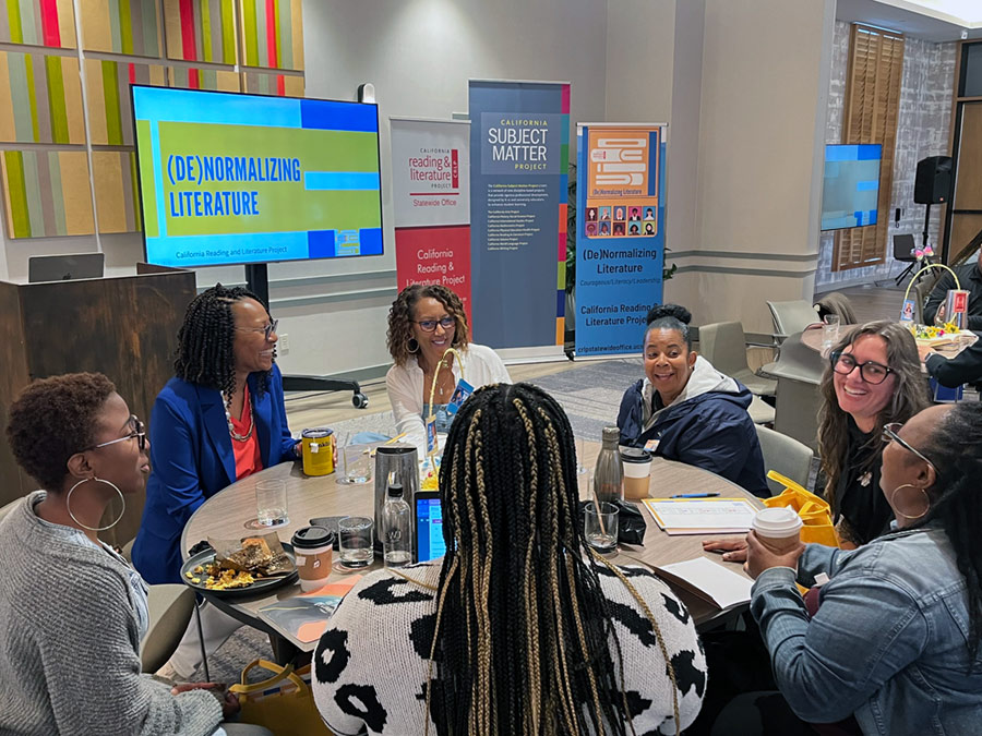 Attendees take notes and listen during a presentation at a CRLP event